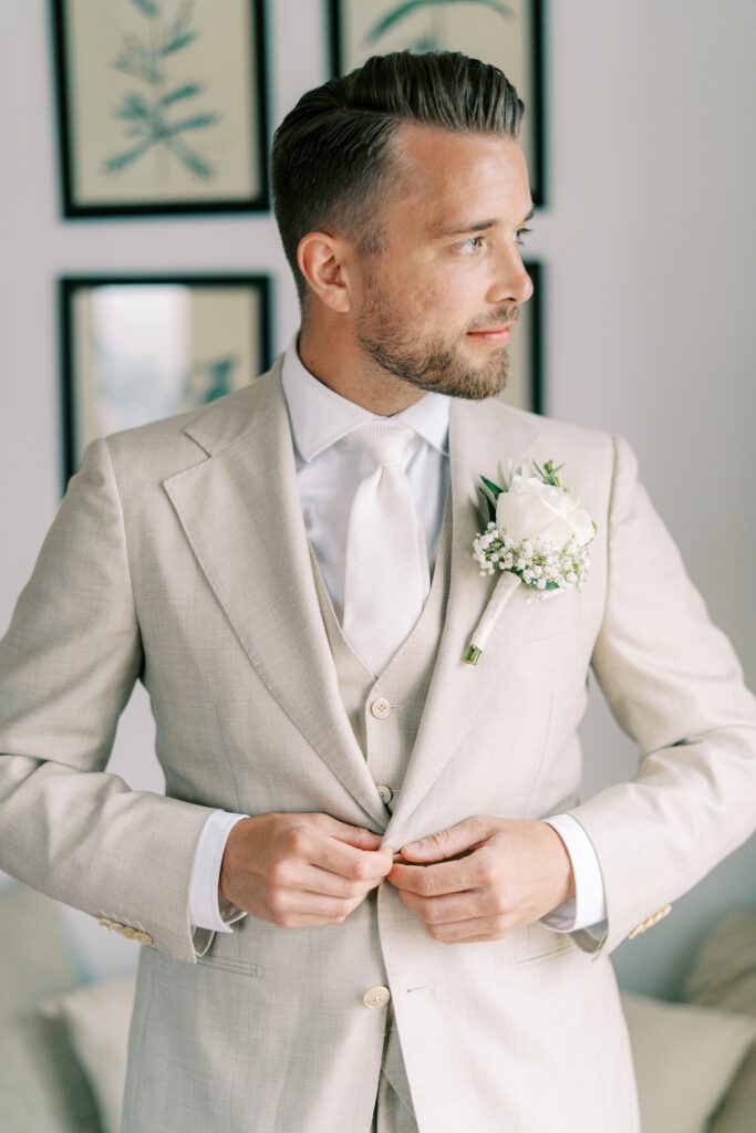 Groom in grey suit preparing for wedding in Spain